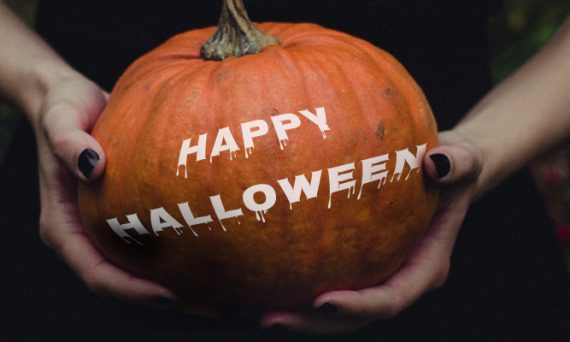 2 Hands Holding Pumpkin with White Happy Halloween Text