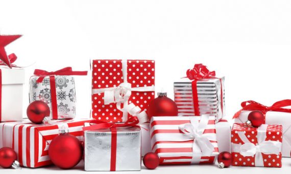 Pile of Christmas Gifts in Red and White Wrapping Paper with Red Ornaments on White Background