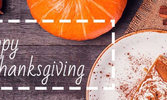 Overhead View of Table with Pumpkin Pie and Small Orange Gourd with White Happy Thanksgiving Text