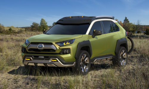 Wide shot of Toyota FT-AC concept parked in field