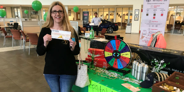 Winner of $500 Voucher at Toyota of Hattiesburg Lucky Leprechaun Madness Sale in Front of Prize Wheel