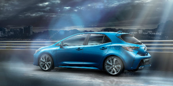 Blue 2019 Toyota Corolla Hatchback Rear and Side Exterior on Freeway in Fog