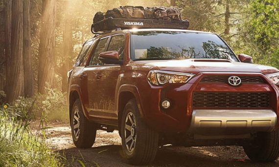 Barcelona Red Metallic 2018 Toyota 4Runner with Luggage Rack on Wooded Trail