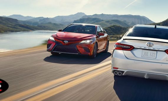 Red and Silver 2018 Toyota Camry Models on Curvy Coast Road with Red and Black Toyota Certified Used Vehicle Badge in Foreground
