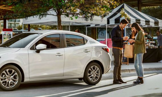 White 2019 Toyota Yaris Sedan Parked at a Farmer's Market
