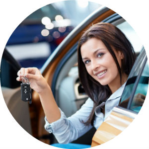 Woman Sitting in the Driver's Seat of a Car with the Door Open Smiling and Holding Keys