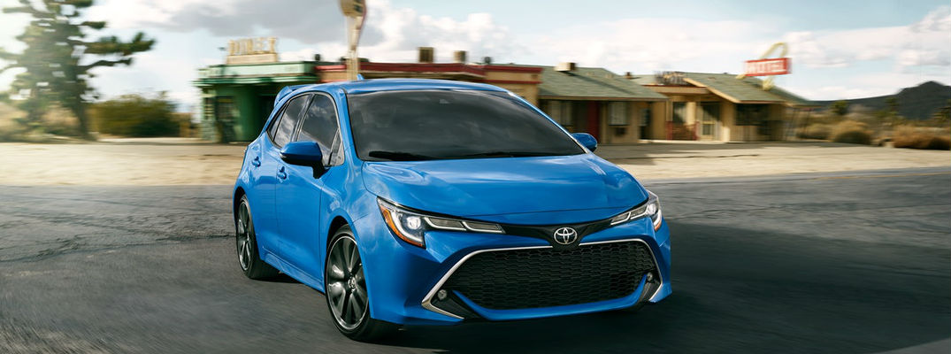 Blue 2019 Toyota Corolla Hatchback XSE Driving Past an Old Diner