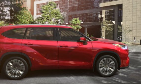 2020 Toyota Highlander exterior passenger side profile on street with trees